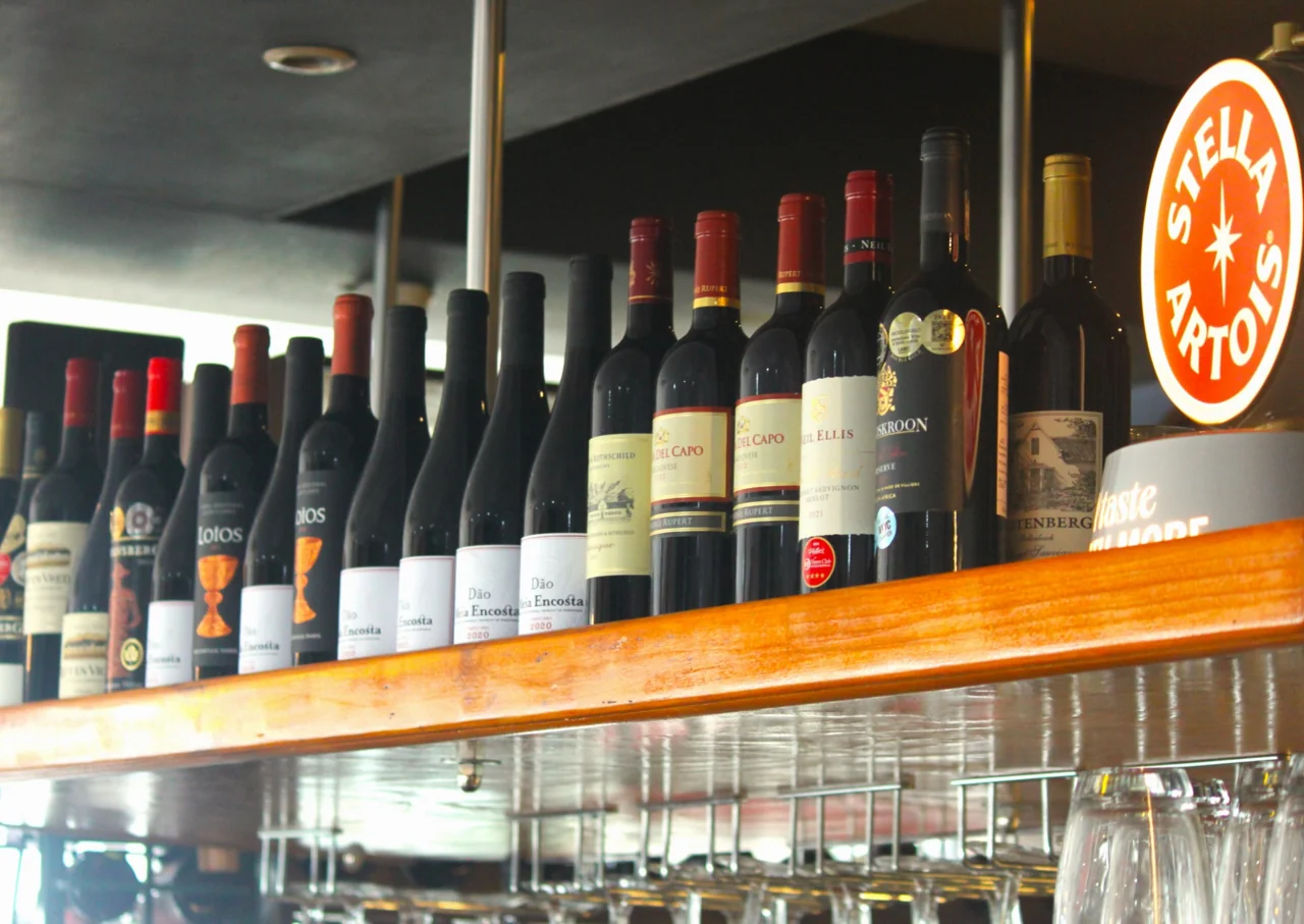 Bottles and glassware on the wooden bar at O Pescador
