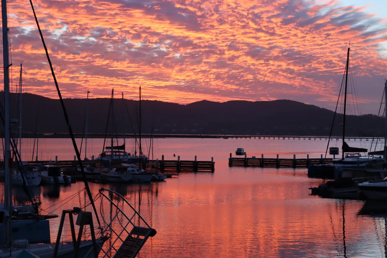 A vivid sunset over the boats at Knysna Waterfront