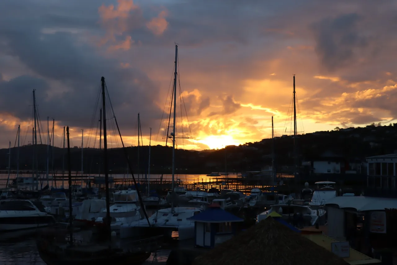 Gold and orange sunset above the sailboats at Knysna Waterfront