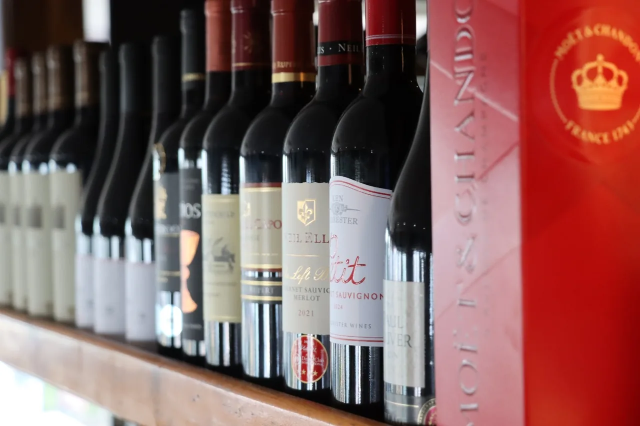 A row of wine bottles on the wooden shelves at O Pescador