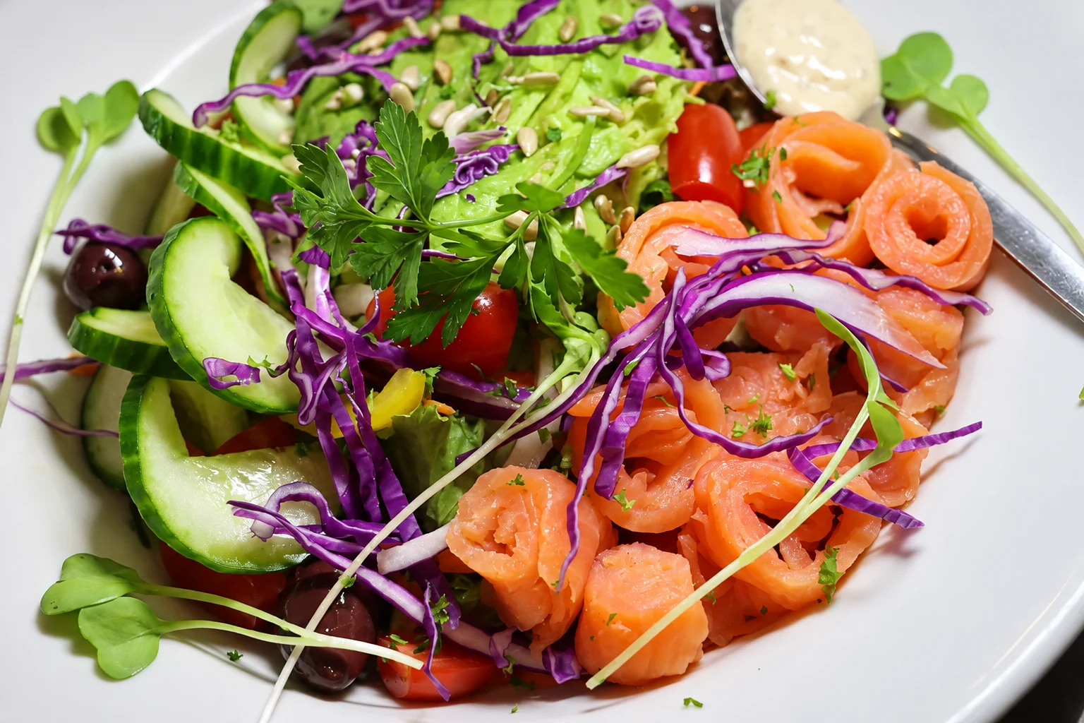 Smoked salmon salad with fresh greens, cucumber and red cabbage