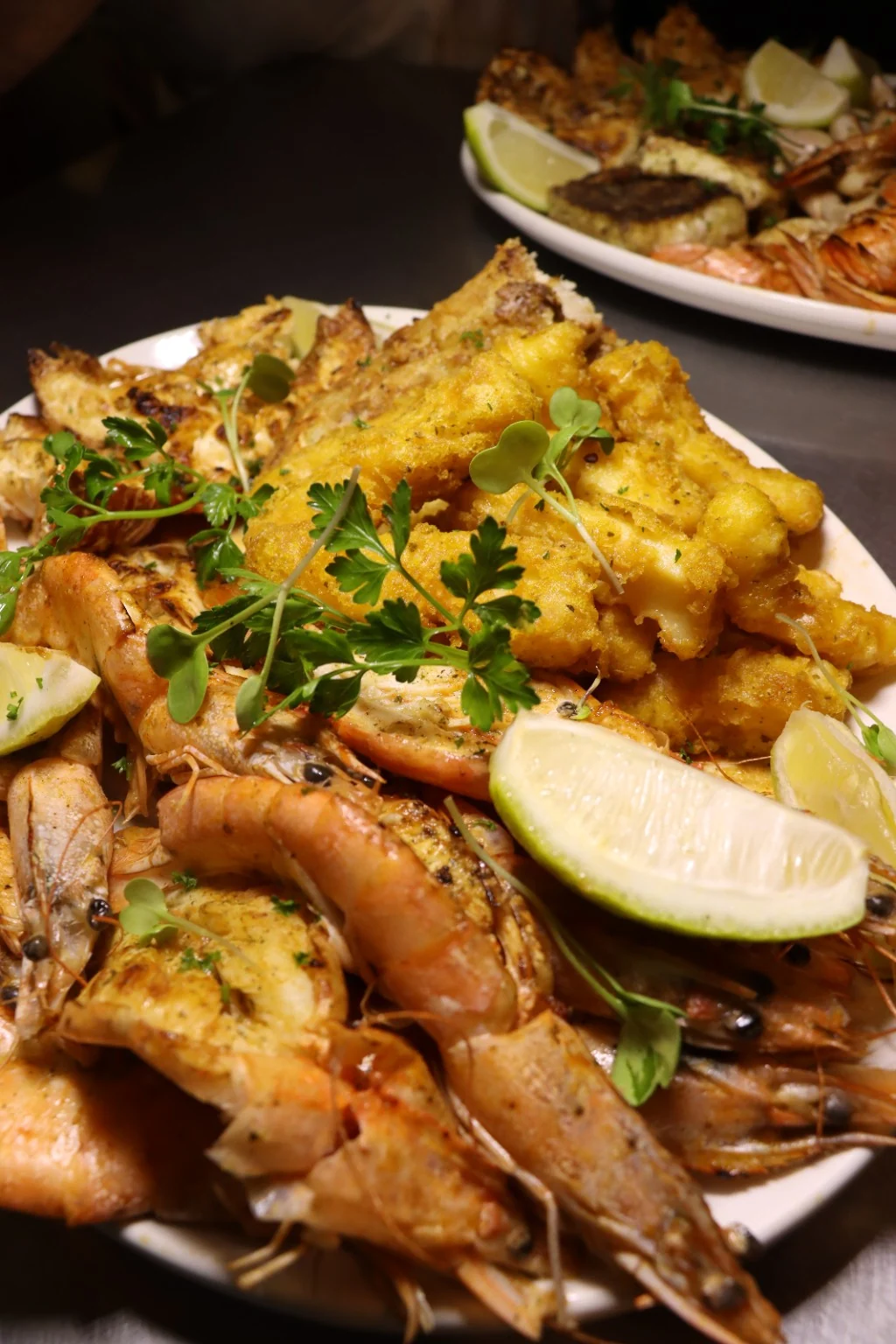 Prawns, calamari and golden fish with lemon on a seafood platter